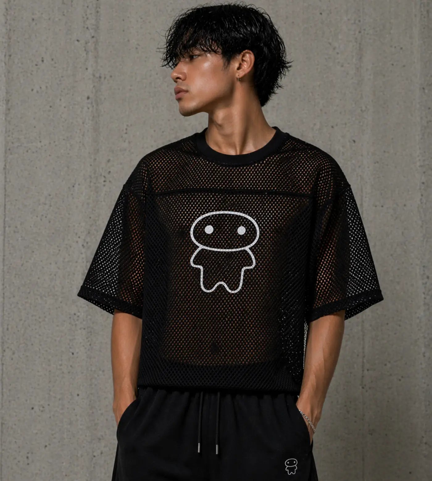 Model wears a black boxy mesh T-shirt featuring a Lil Alien Bae graphic. 