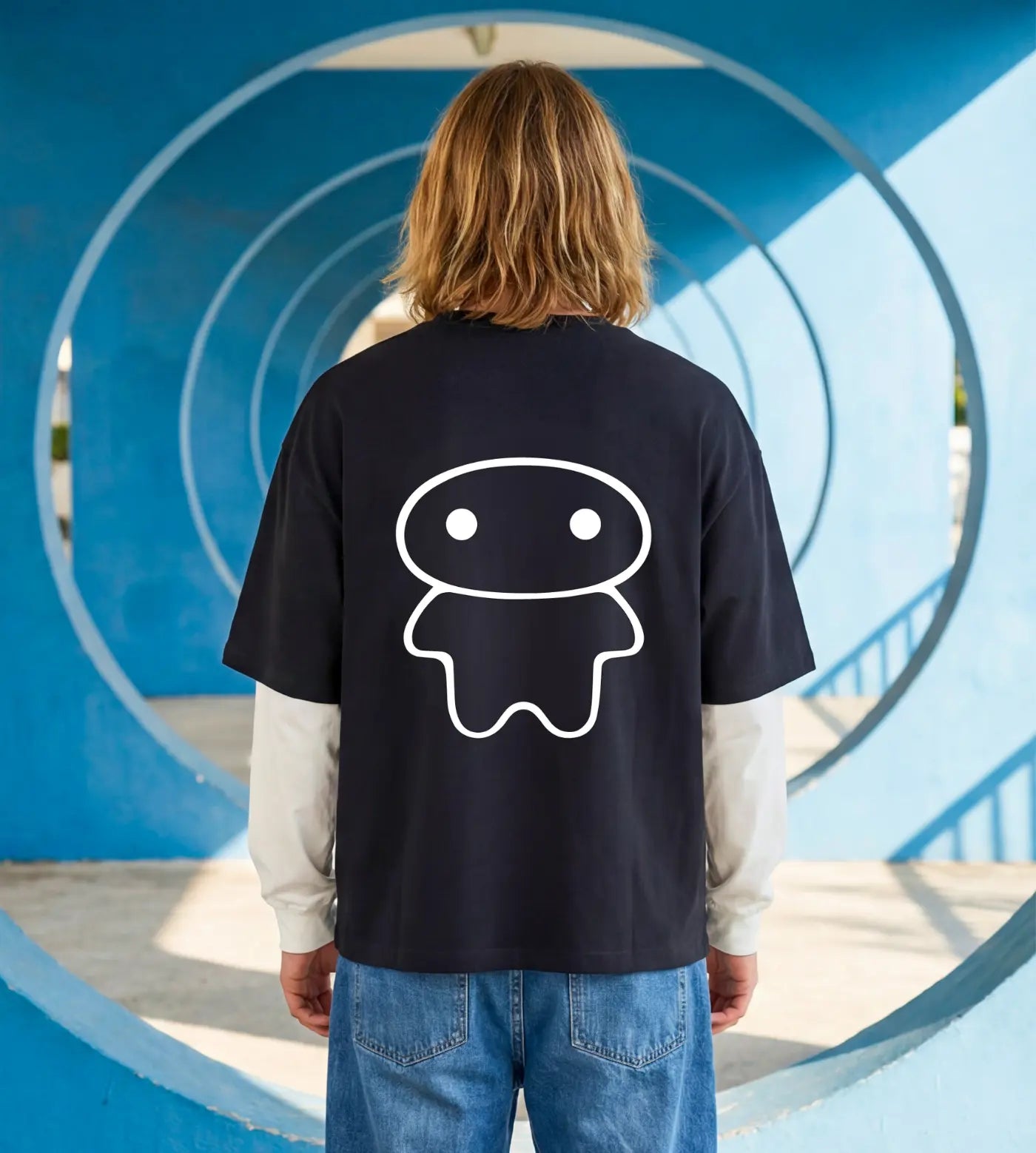 Model wears a black layered long sleeve T-shirt featuring a Lil Alien Bae back graphic.  