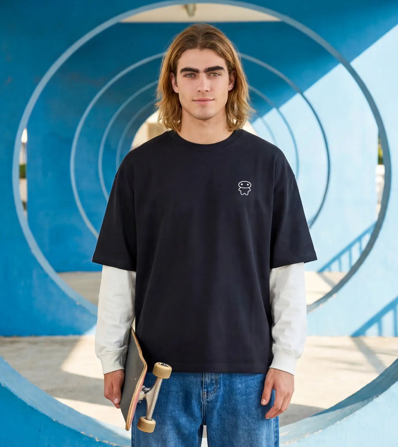 Model wears a black layered long sleeve T-shirt featuring a Lil Alien Bae chest graphic.  