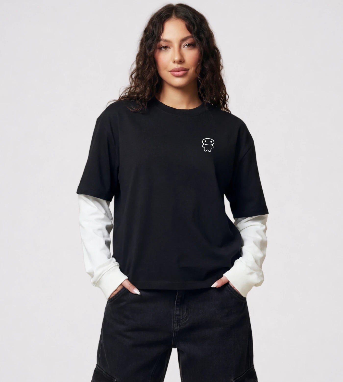 Model wears lack layered long sleeve T-shirt featuring a Lil Alien Bae chest graphic.  
