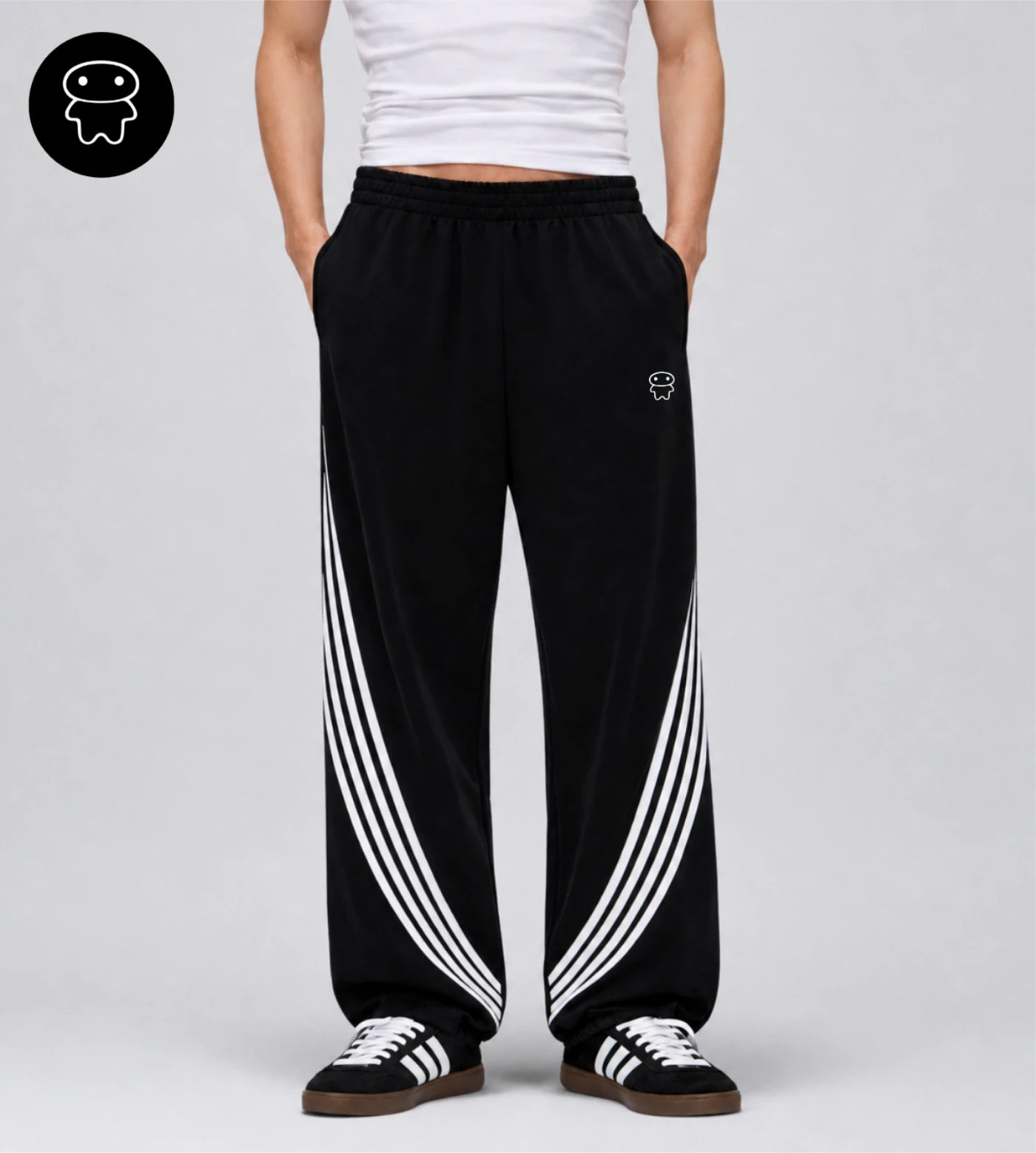 Model wears black curved stripe sweatpants featuring a small Lil Alien Bae graphic. 