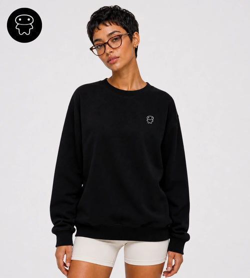 Model wears a black heavyweight cotton sweatshirt featuring a small Lil Alien Bae chest graphic. 