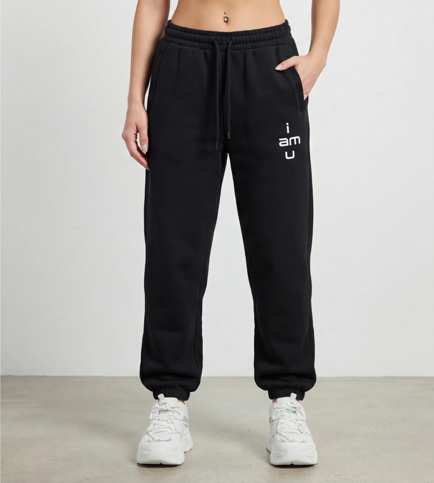 Model wears black fleece joggers featuring an "i am u" graphic. 