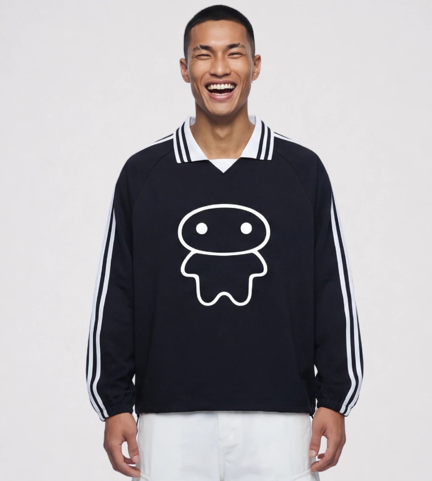 Model wears a black lapel collar pullover featuring a Lil Alien Bae graphic. 