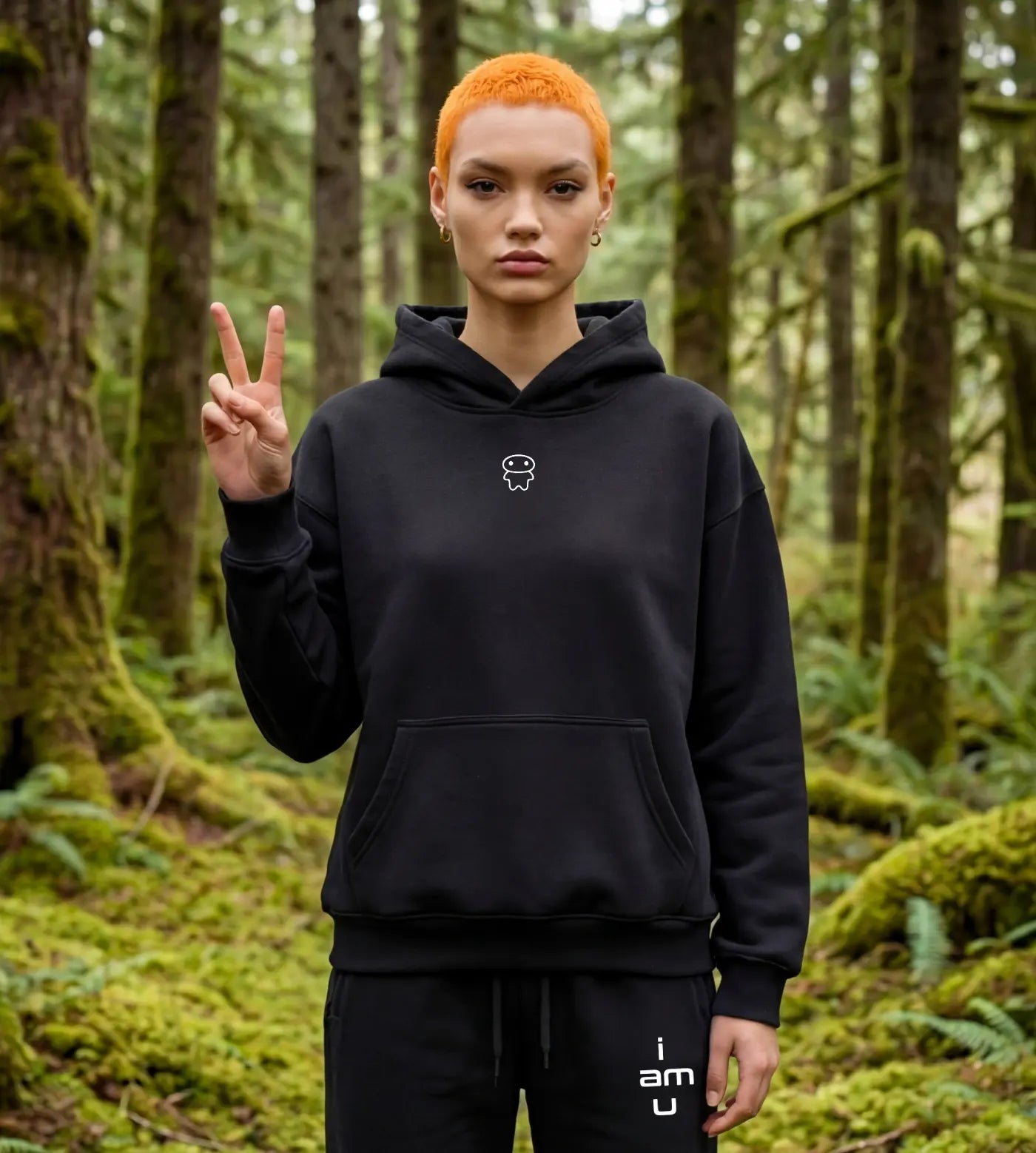 Model wears a black oversized fleece hoodie featuring a small Lil Alien Bae graphic. 