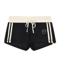 Black and cream striped varsity shorts featuring a Lil Alien Bae. 