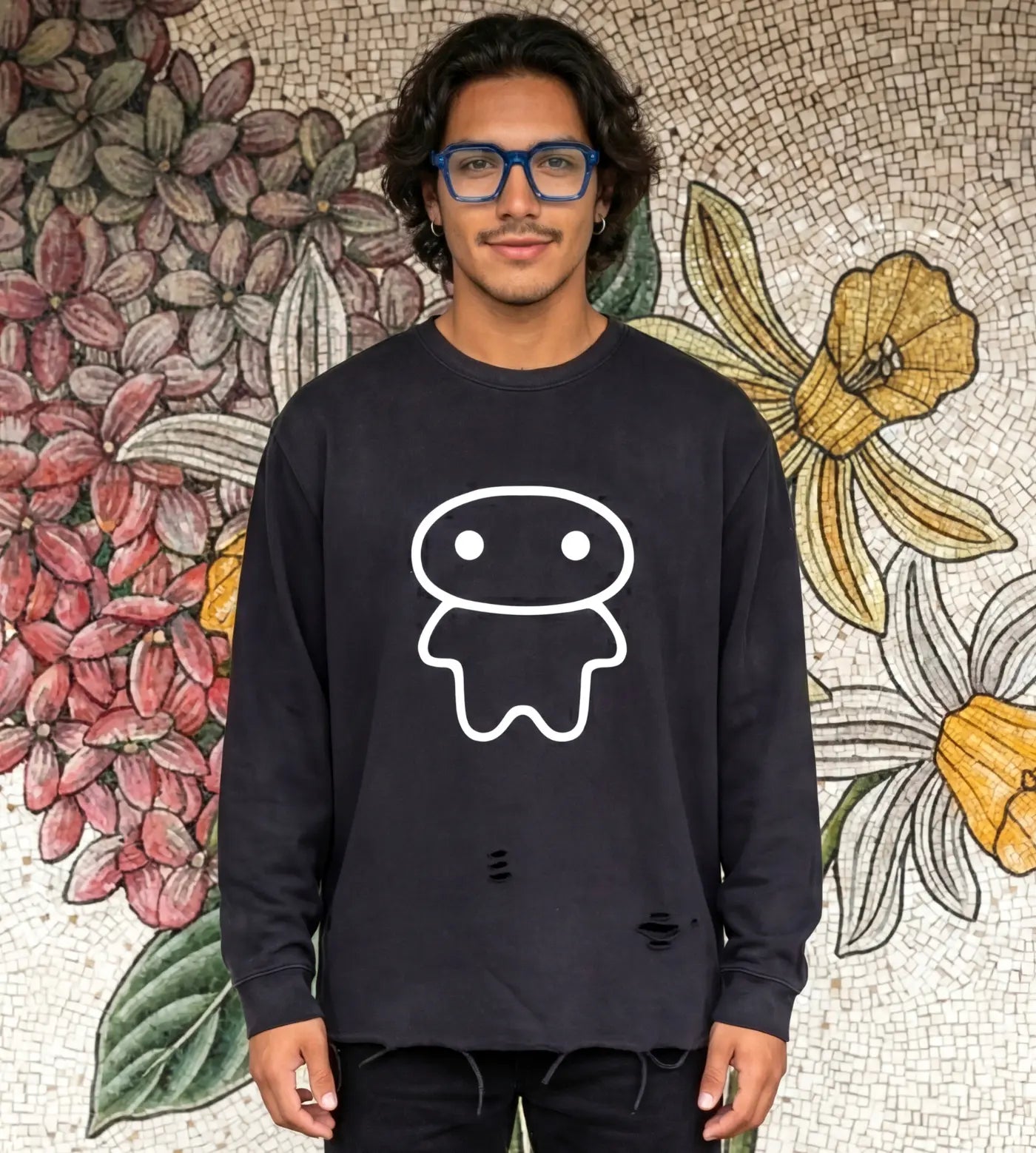 Model wears a black vintage washed long sleeve shirt with raw edge hem and Lil Alien Bae graphic.  