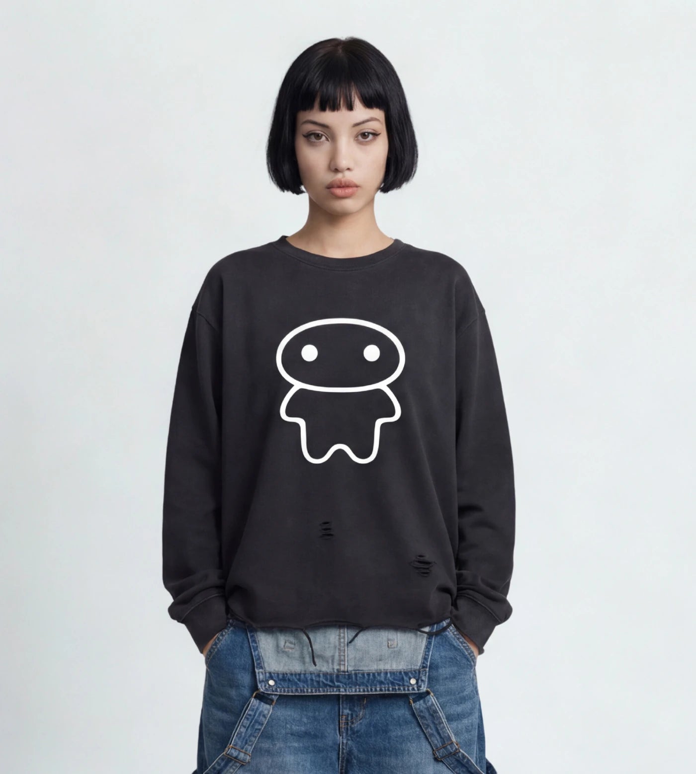 Model wears a black vintage washed long sleeve shirt with raw edge hem and Lil Alien Bae graphic.  
