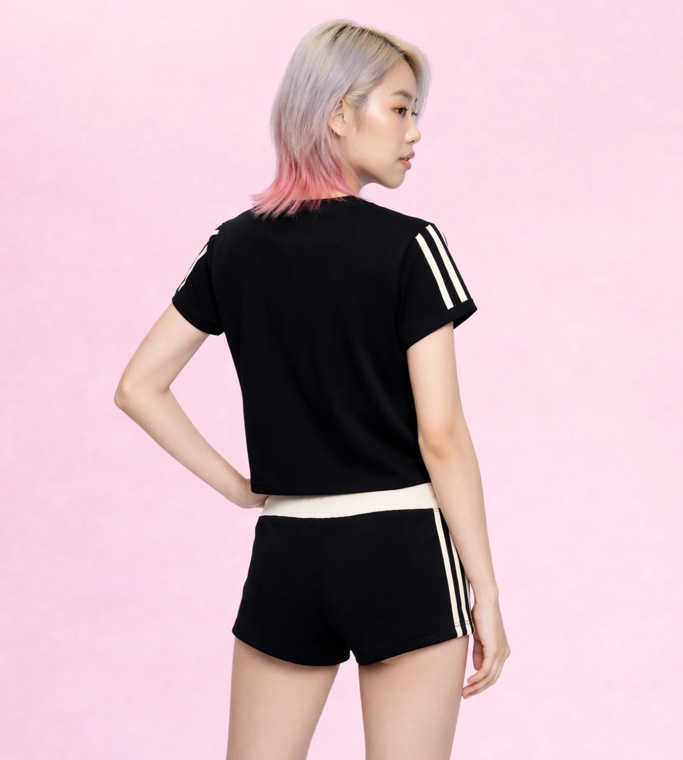 Model wears a black varsity stripe cropped T-shirt set.