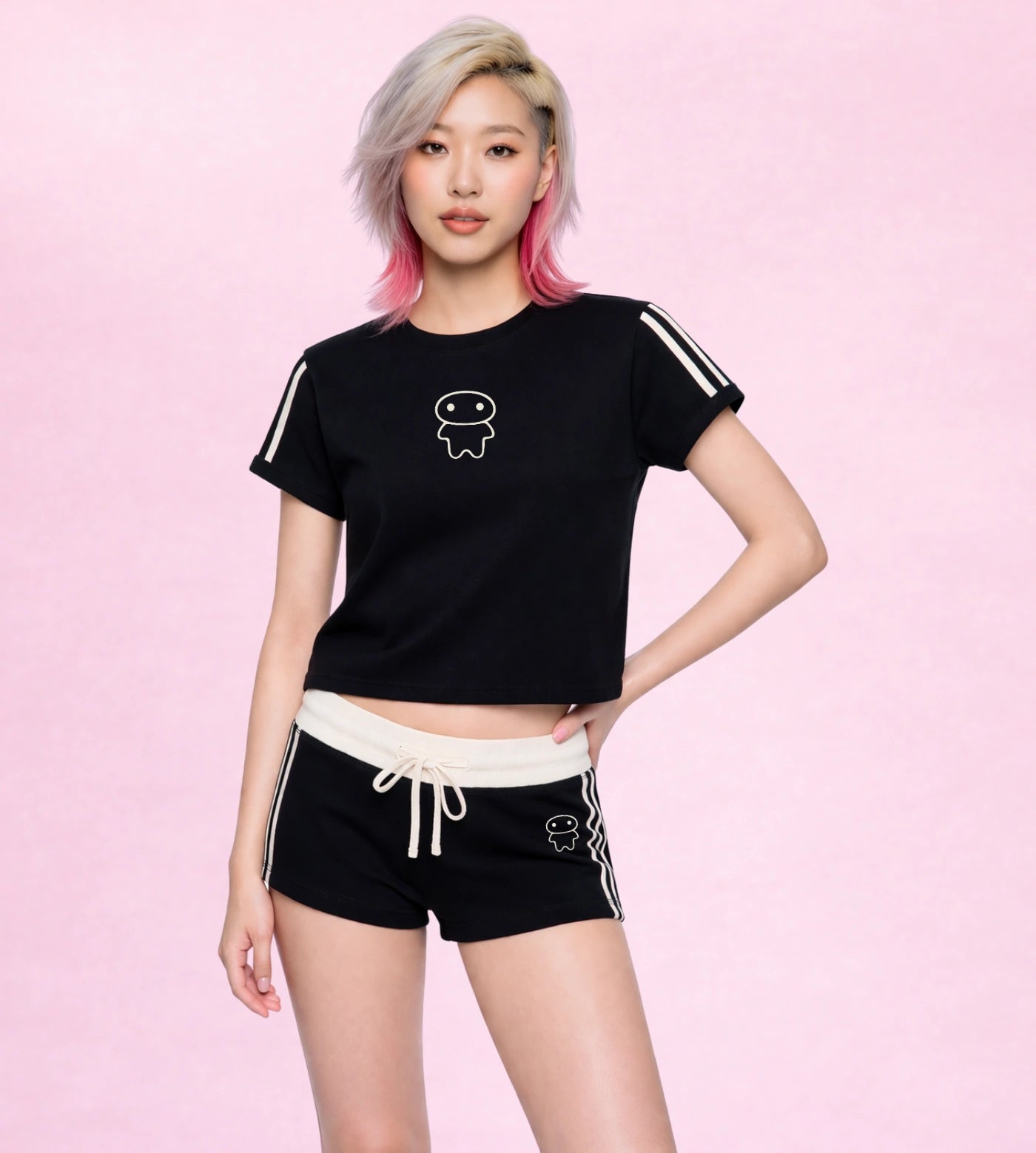 Model wears a black varsity stripe cropped T-shirt set featuring a Lil Alien Bae graphic. 