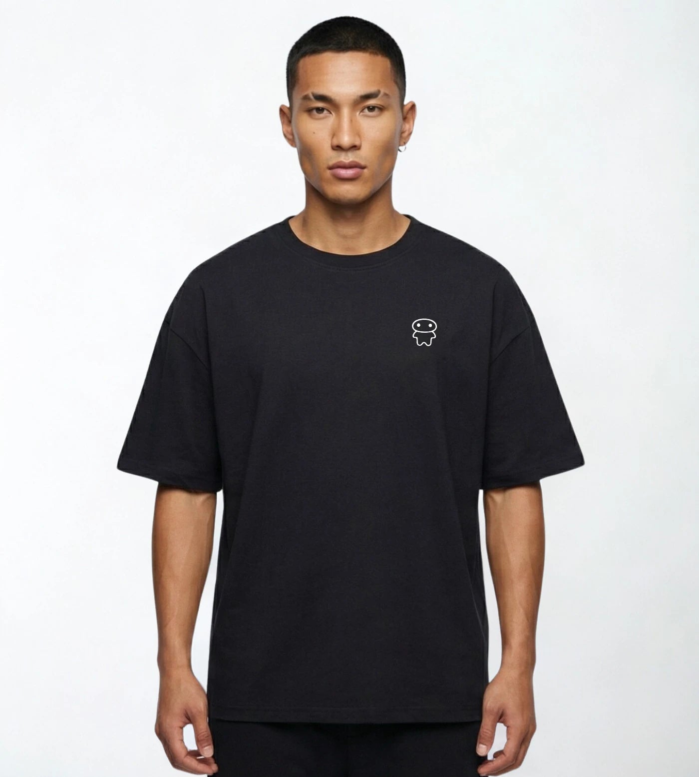 Model wears a black wide fit cotton T-shirt featuring a Lil Alien Bae chest graphic. 