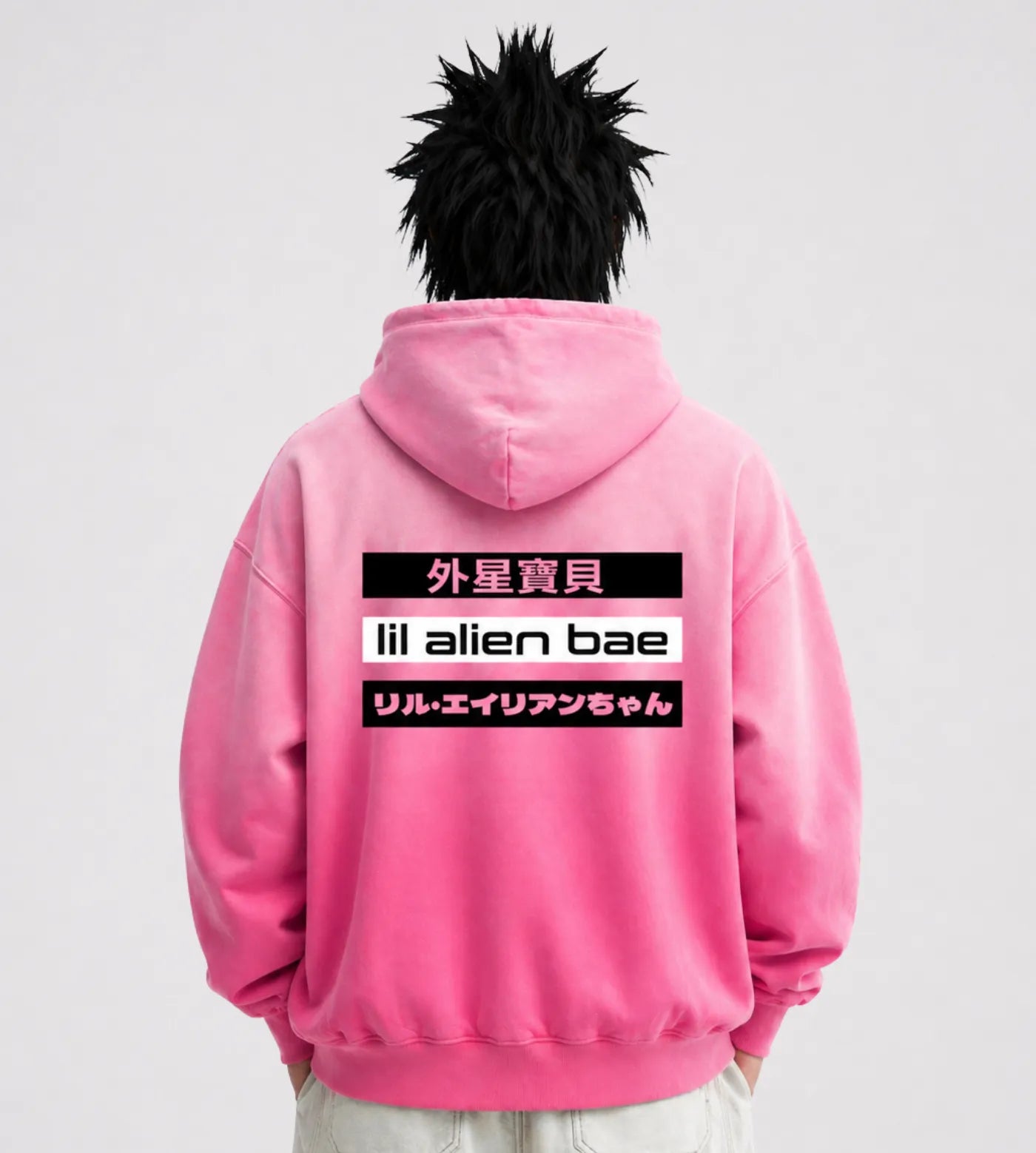 Model wears a hot pink sunfaded oversized hoodie featuring a Lil Alien Bae trilingual back graphic. 