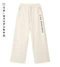 Light cream straight-leg sweatpants featuring Lil Alien Bae in Japanese.  