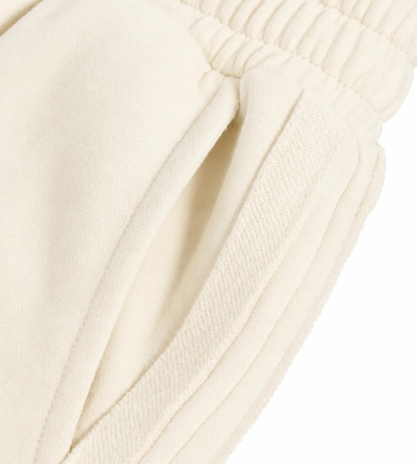 Light cream straight-leg sweatpants featuring pockets and a contrast stripe.  