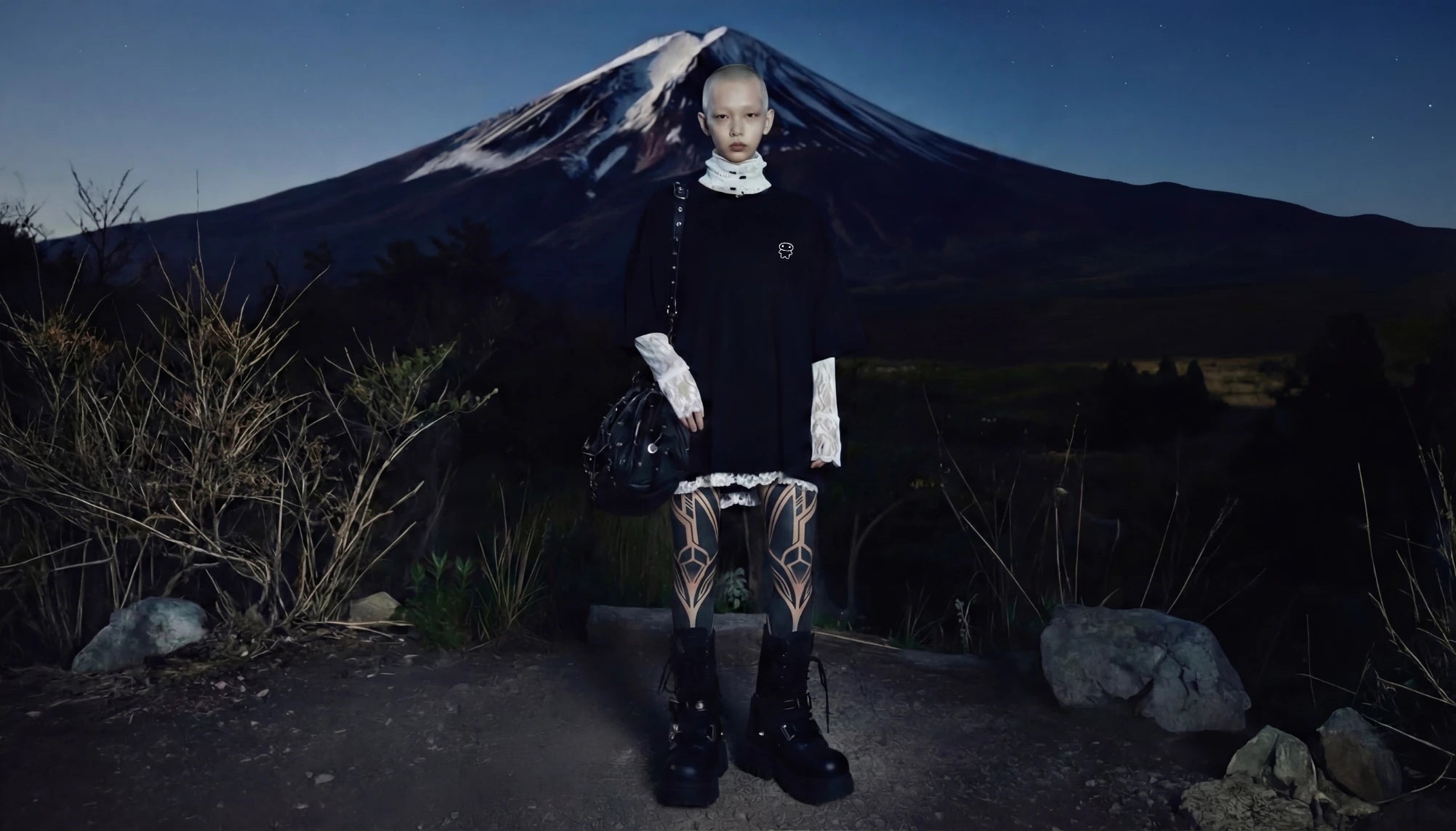 Lil Alien Bae's In'Yo collection shows a model styling an oversized black cotton T-shirt featuring a Lil Alien Bae graphic in Japan.  