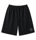 Black drawstring shorts with a small white cartoon character graphic on the lower left leg, shown against a plain white background.