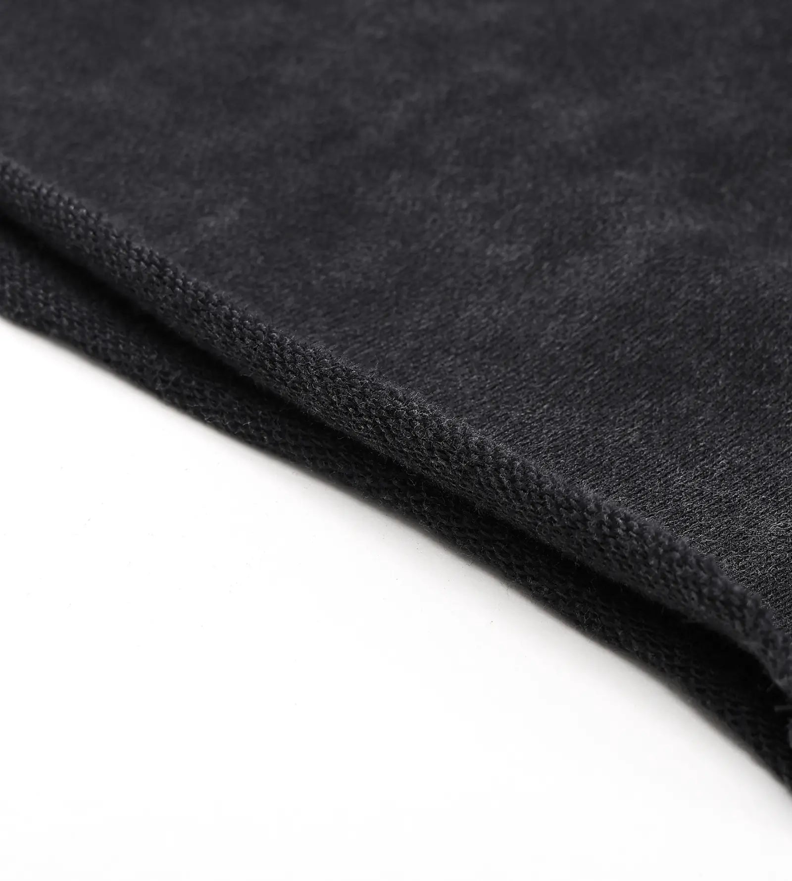 Close-up of dark gray fabric texture on a white background