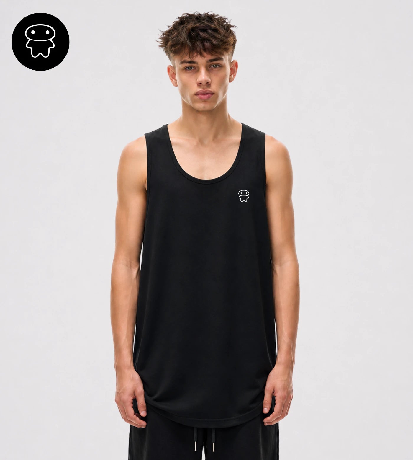 Model wears a black loose fit wide arm cotton tank top featuring a Lil Alien Bae chest graphic. 