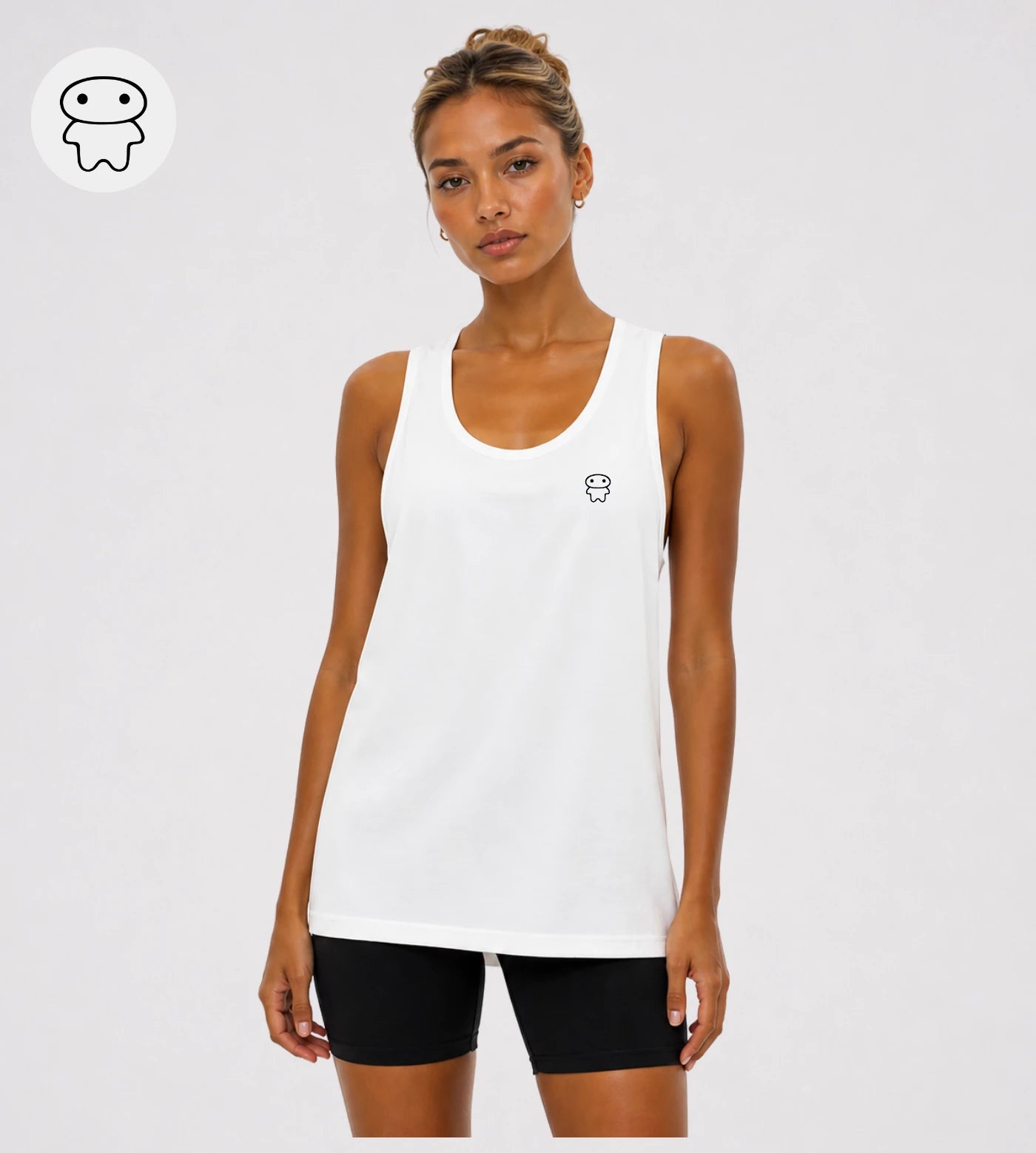 Model wears a white loose fit wide arm tank top featuring a Lil Alien Bae chest graphic.  