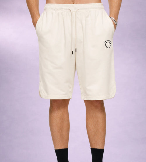 Model wears off white athletic shorts featuring a Lil Alien Bae graphic. 