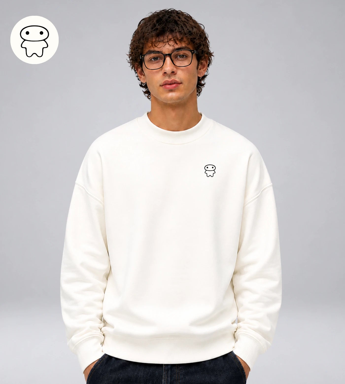 Model wears an off white heavyweight cotton sweatshirt featuring a small Lil Alien Bae chest graphic. 