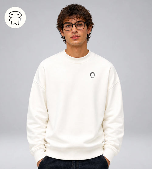 Model wears an off white heavyweight cotton sweatshirt featuring a small Lil Alien Bae chest graphic. 