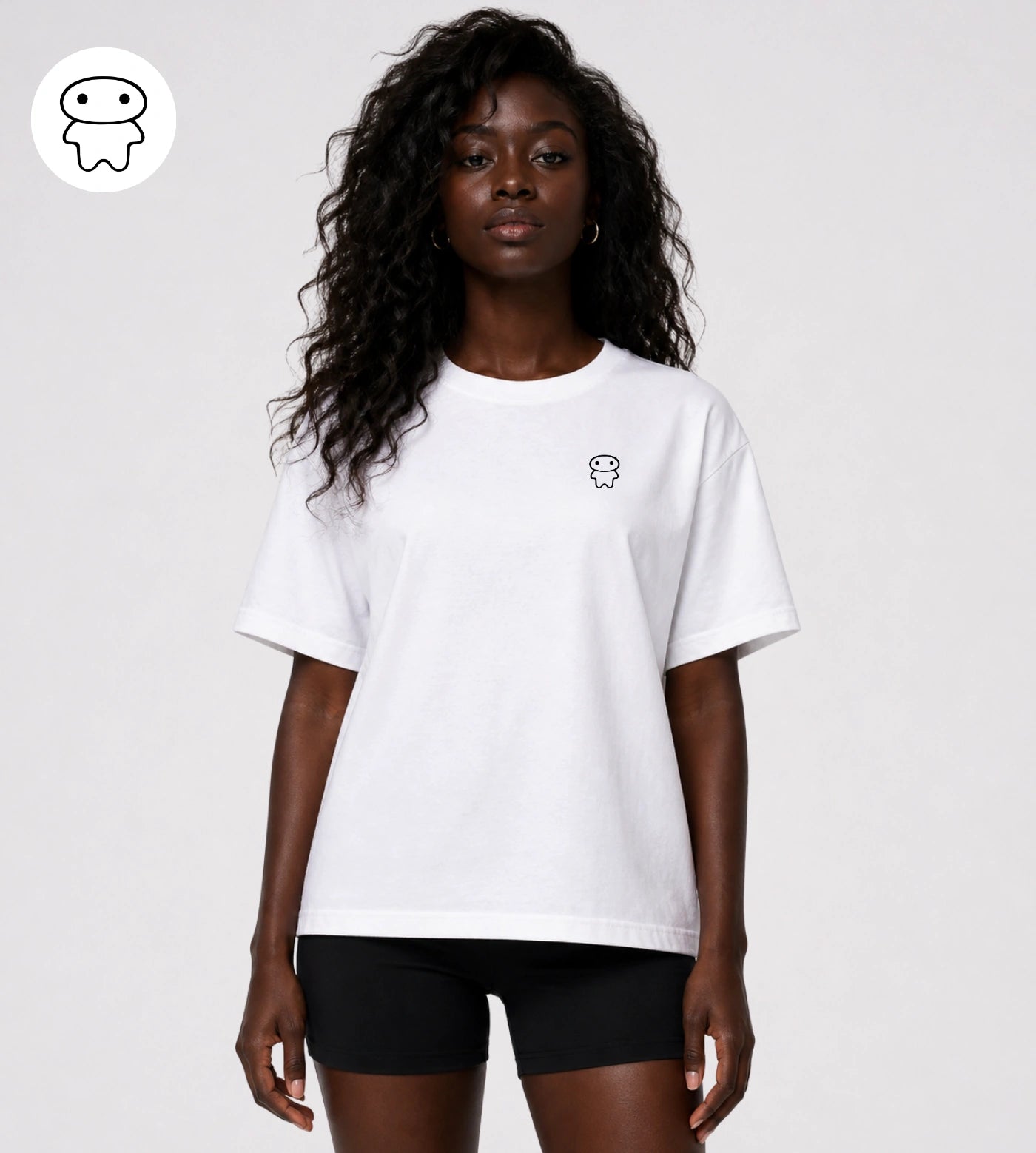 Model wears a relaxed fit white cotton T-shirt featuring a small Lil Alien Bae chest graphic. 