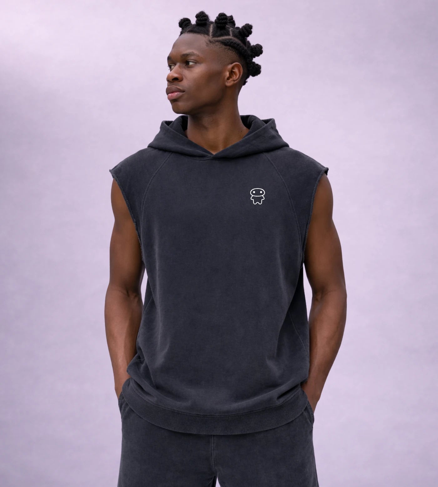 Model wears a black snow washed sleeveless hoodie featuring a Lil Alien Bae chest graphic. 