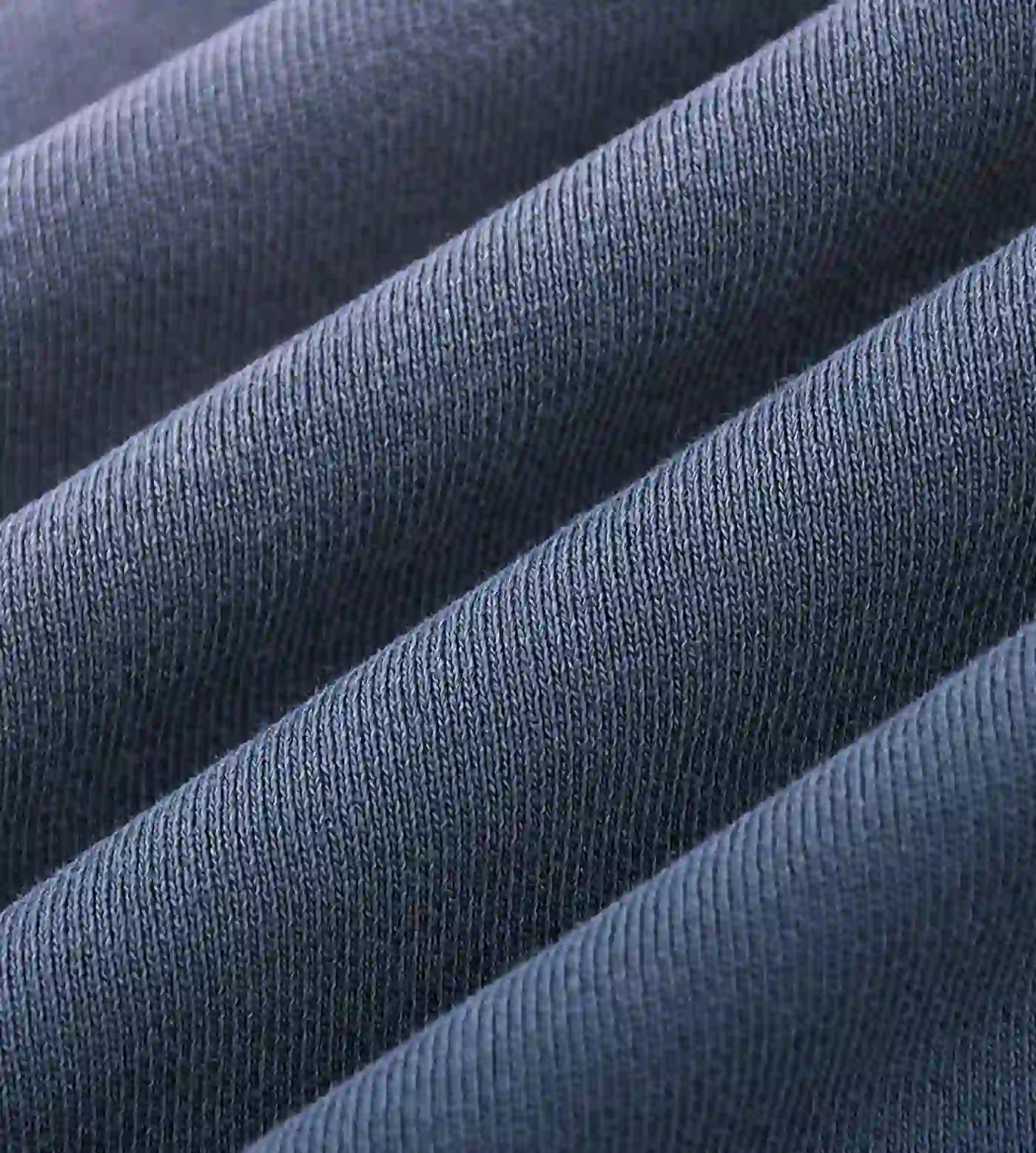 Sunfaded blue gray cotton sweatshirt fabric texture. 