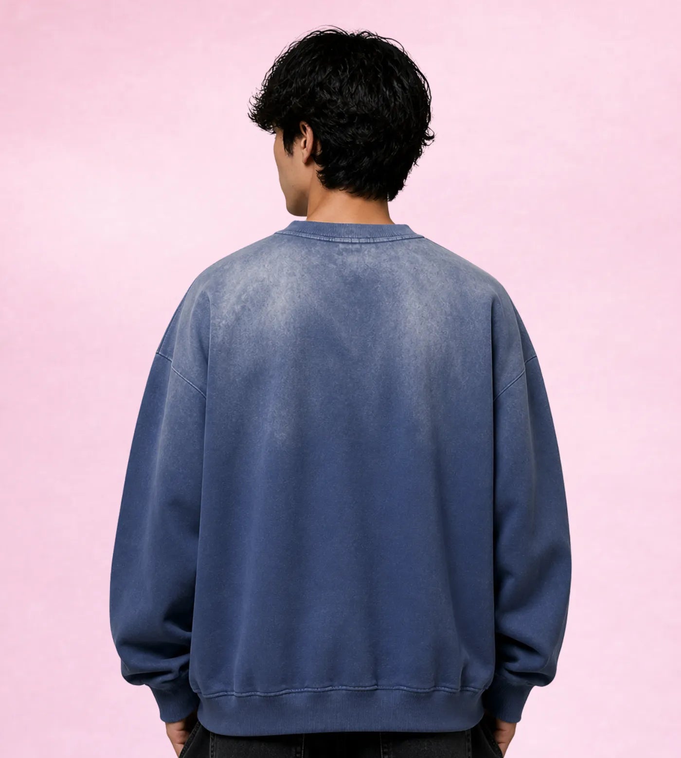 Model wears a sunfaded blue gray cotton sweatshirt featuring a Lil Alien Bae sakura chest graphic. 