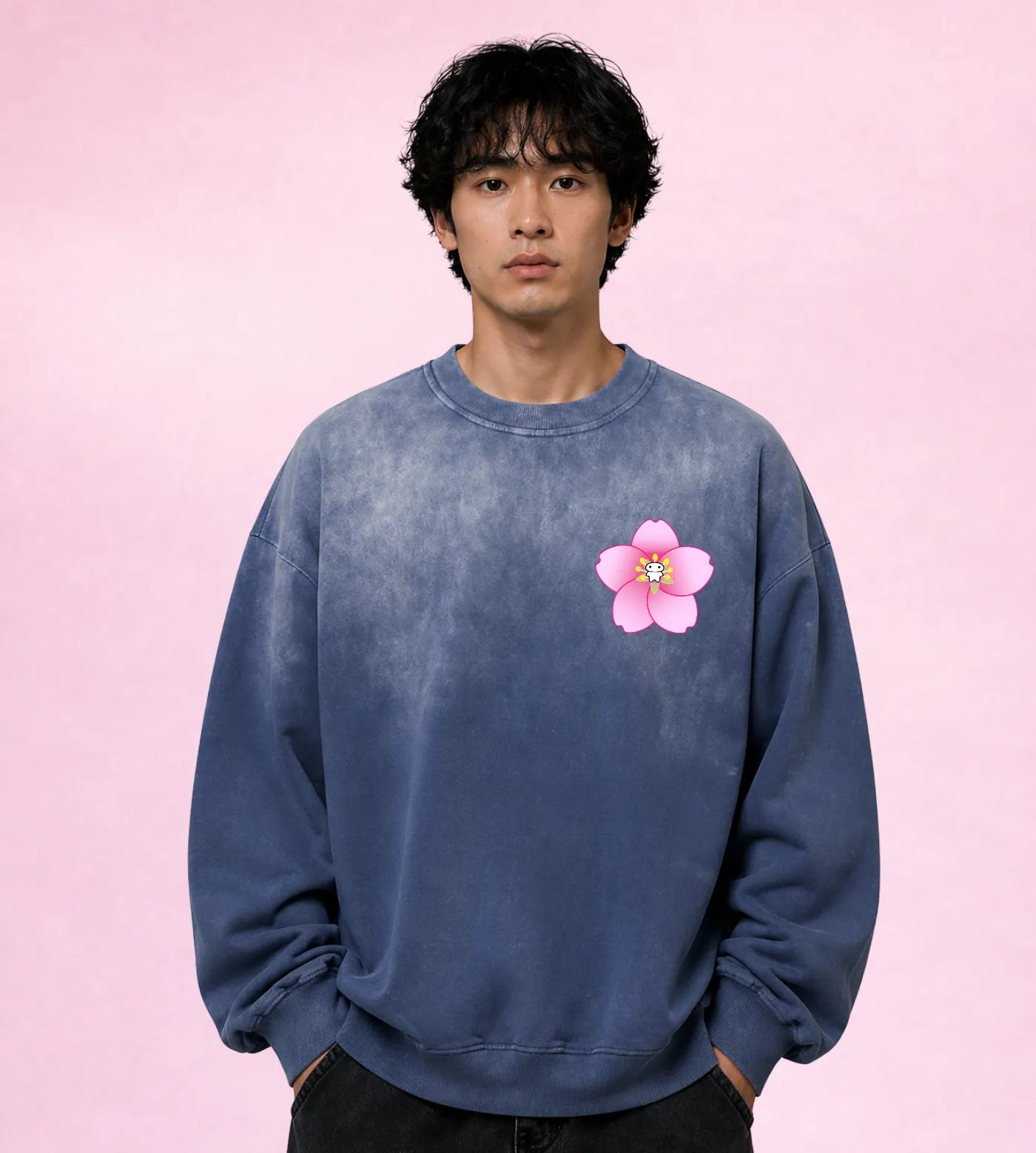 Model wears a sunfaded blue gray cotton sweatshirt featuring a Lil Alien Bae sakura chest graphic. 
