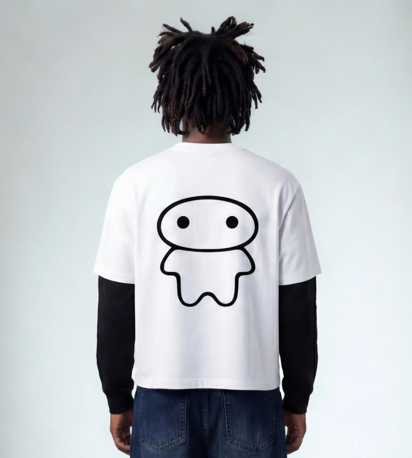 Model wears a white layered long sleeve T-shirt featuring a Lil Alien Bae back graphic. 