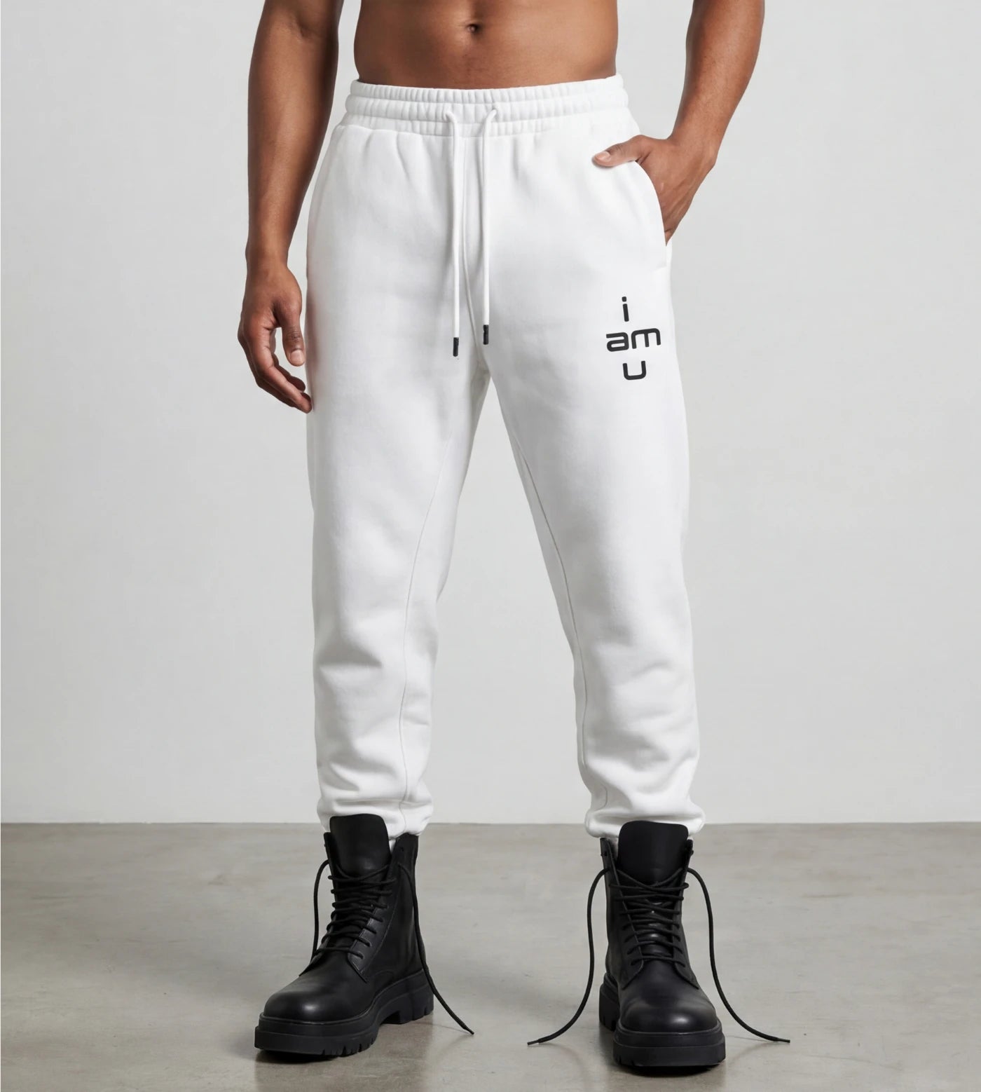 Male model wears white fleece joggers featuring an "i am u" graphic.  