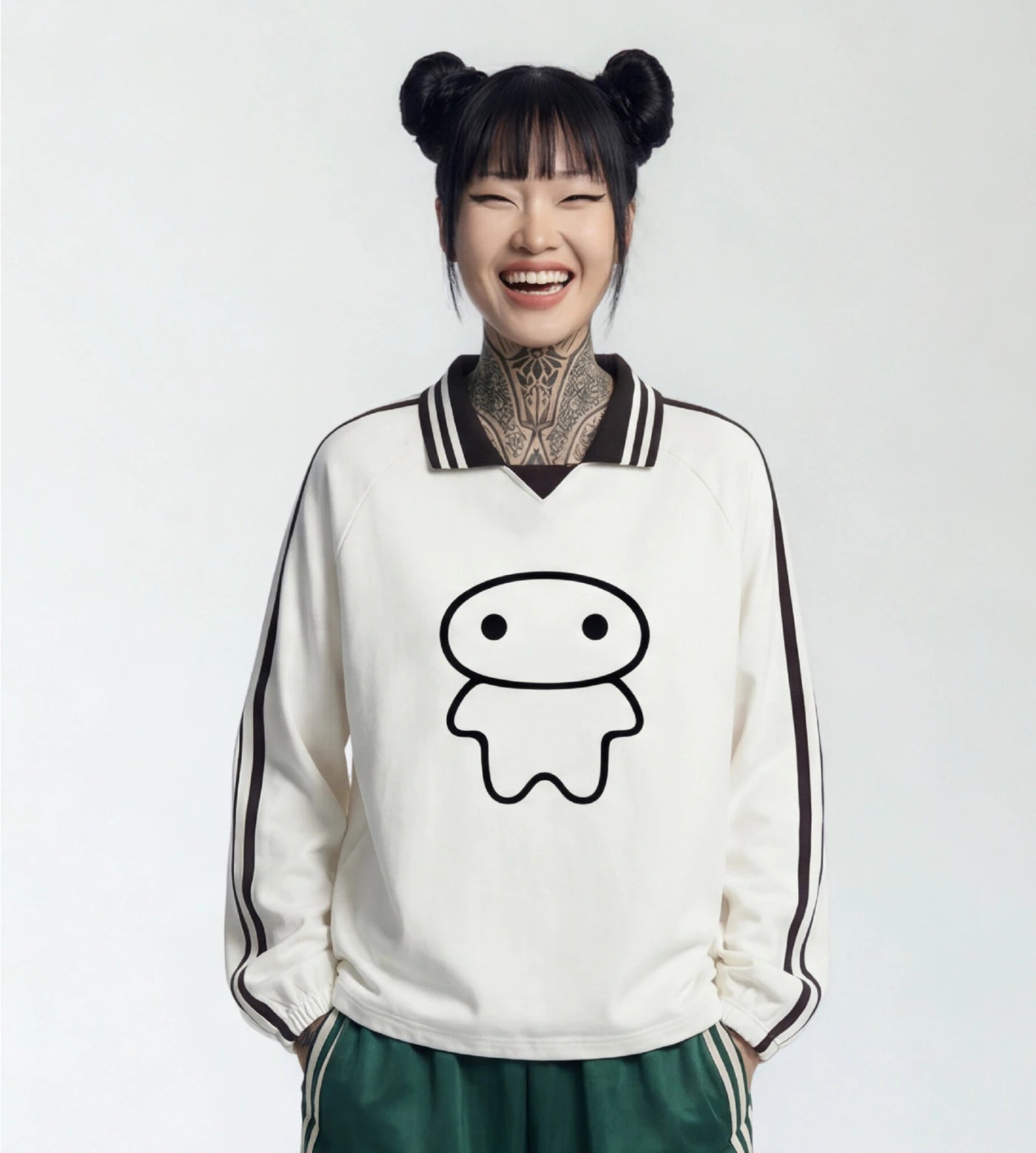 Model wears an off white lapel collar pullover featuring a Lil Alien Bae graphic.