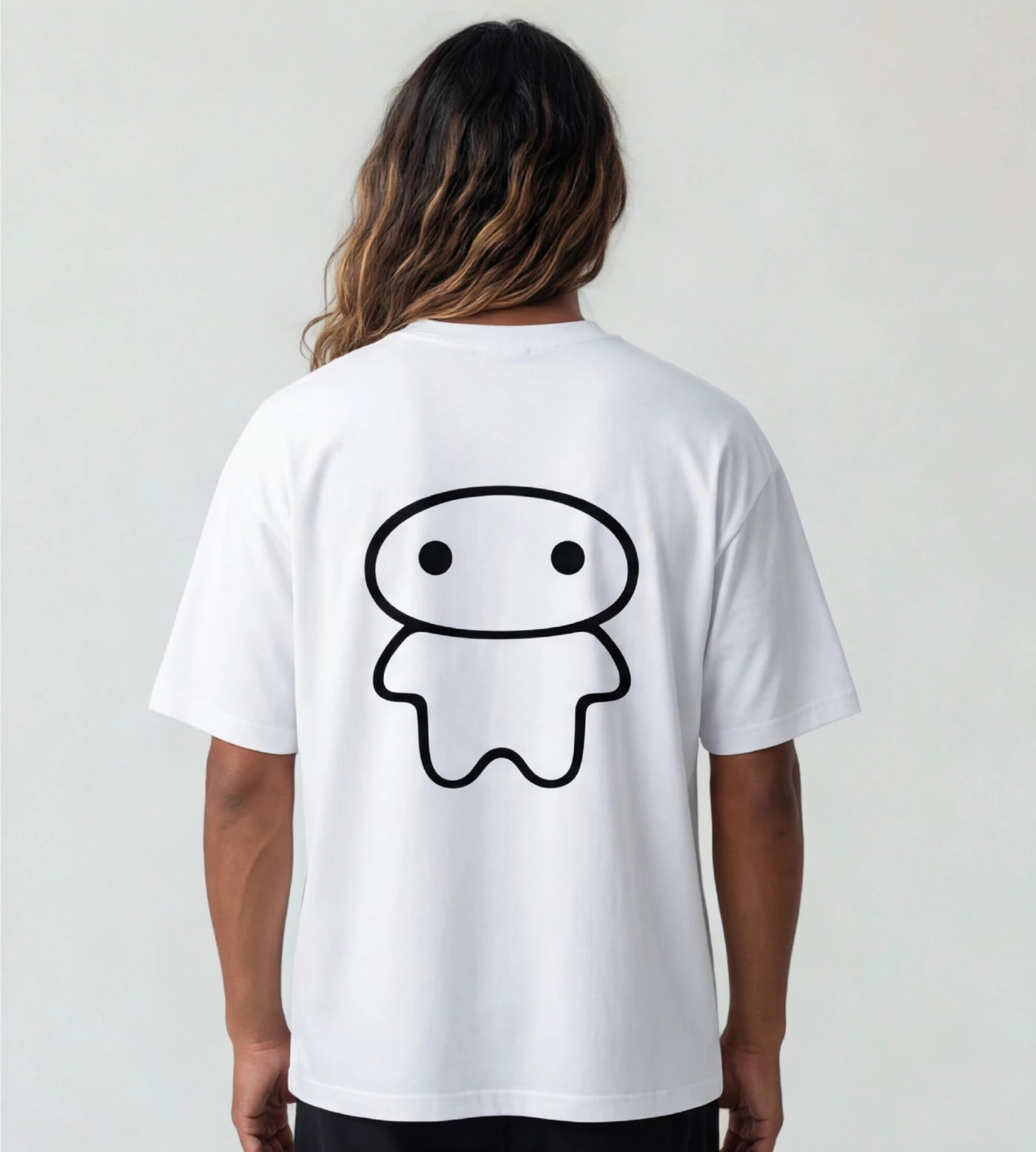Model wears a white wide fit cotton T-shirt featuring a Lil Alien Bae back graphic. 