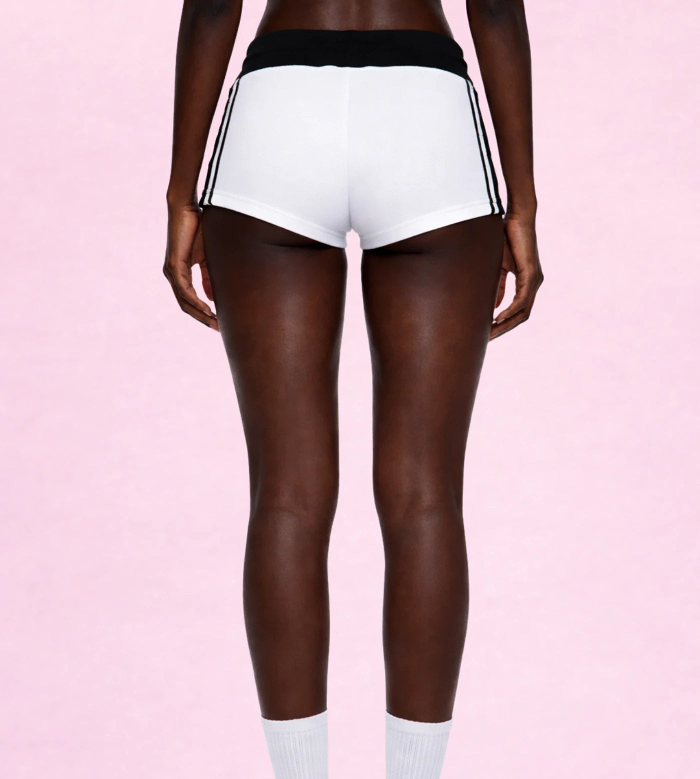 Model wears white varsity stripe shorts.