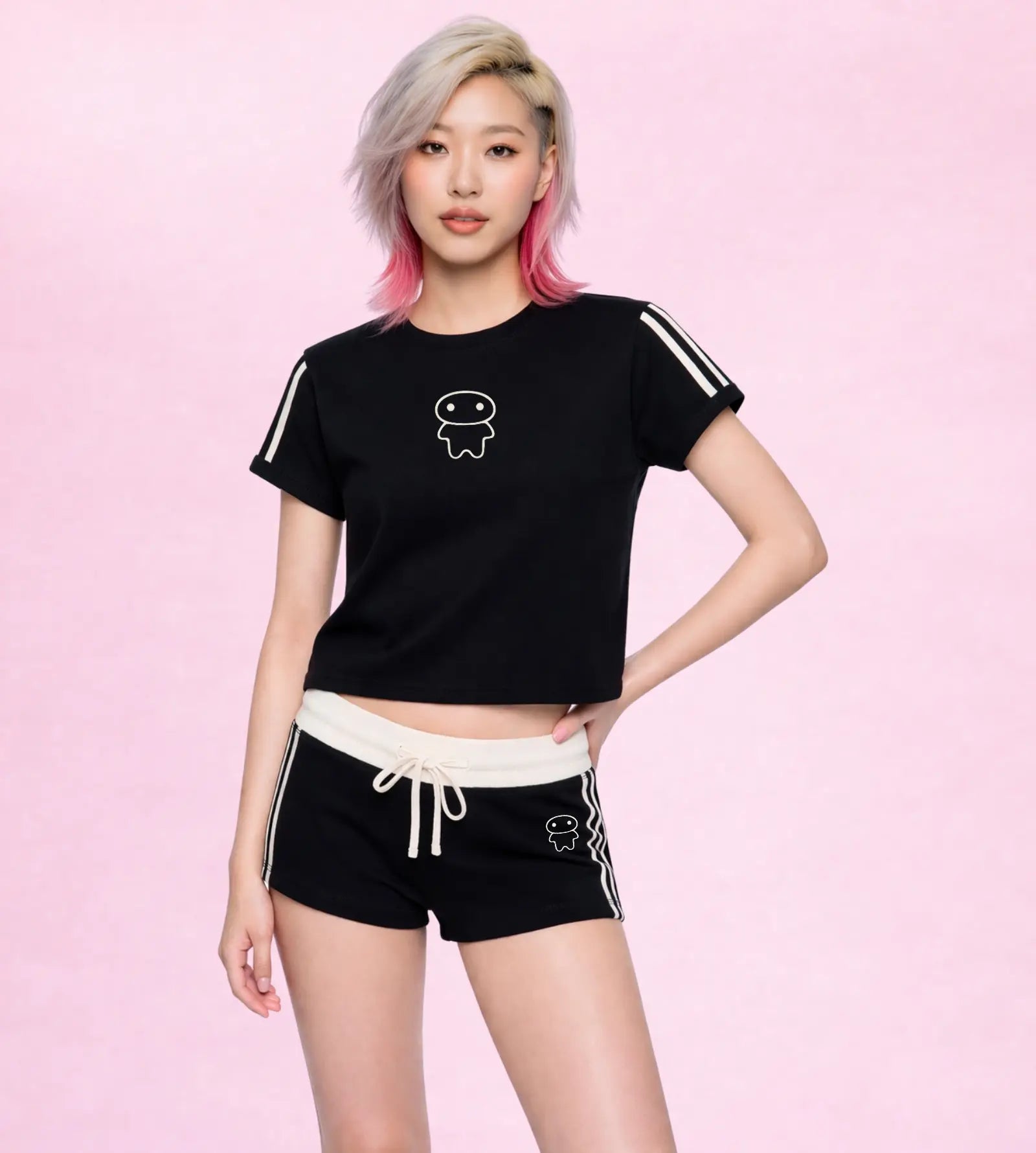 Person wearing a black t-shirt and shorts with white accents on a pink background