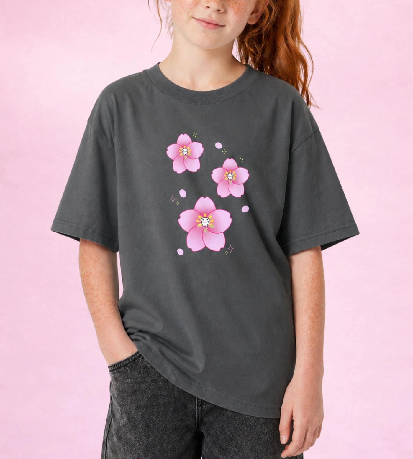 Model wears a youth gray cotton T-shirt featuring a Lil Alien Bae sakura graphic.  