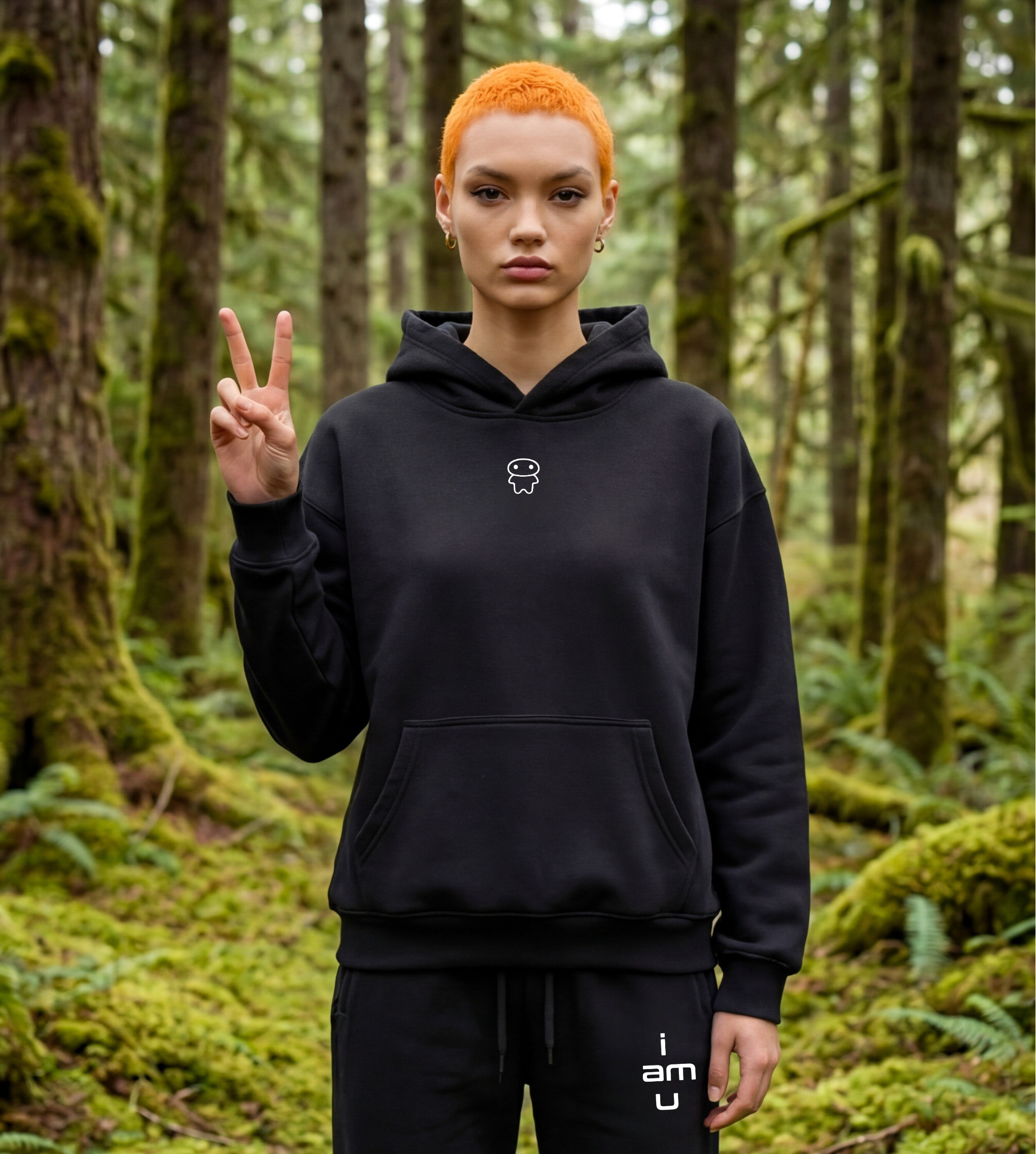 Model wearing a black oversized graphic fleece hoodie with a small lil alien bae chest logo.